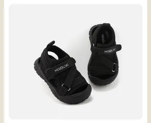 Macro view of black children's sports sandals with soft sole and Velcro straps