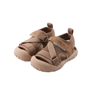 Minimalist breathable mesh closed-toe kids' sandals with velcro straps in tan brown color