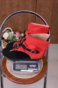 Botas sandalias planas de ante rojo que muestran un peso de 342,3 g