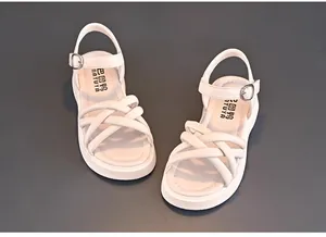 Detailed view of white girls' summer sandals with soft soles and cross strap design