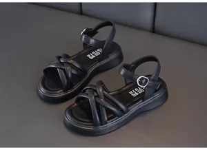 Detailed view of black girls' summer sandals featuring cross-straps and buckle