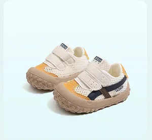 Detailed view of breathable mesh toddler sneakers with double hook and loop straps.