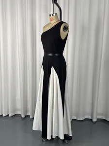 Detailed side view of an elegant one-shoulder black and white patchwork dress on a mannequin