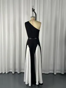 Detailed back view of elegant one-shoulder black and white color block evening dress on mannequin