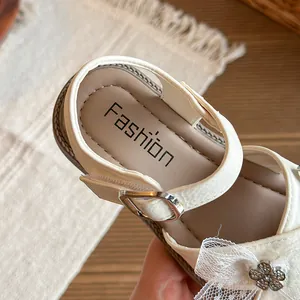 Elegant white girls princess sandals featuring a lace bow and flower closed toe design