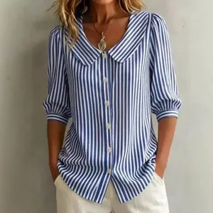Detailed view of women's blue and white striped shirt featuring retro Peter Pan collar