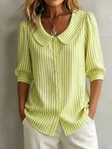 Close-up detail of green striped women's blouse with Peter Pan collar and puff sleeves