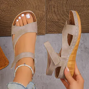 Close-up of beige platform wedge sandals with peep-toe design and adjustable straps