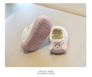 Detail view of pink baby sandals showing anti-slip sole and cute cartoon heel design