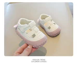 Close-up of white and pink breathable toddler sandals with velcro strap