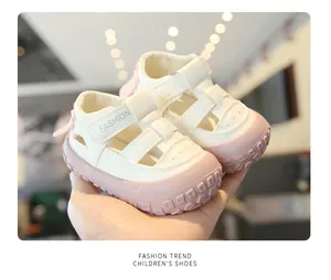 Close-up of breathable white and pink toddler walking sandals with closed-toe design
