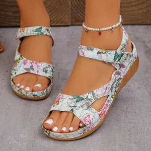 Detailed shot of platform wedge sandals featuring vibrant butterfly print and peep-toe