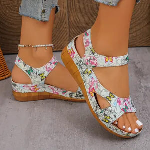 Detail of butterfly print wedge sandals with comfortable thick soles and velcro straps.