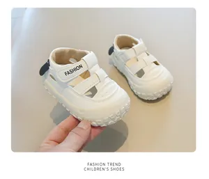 Close-up of white breathable closed-toe children's walking sandals held by person's hand