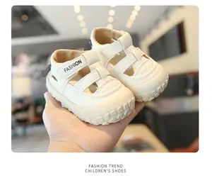 Detailed view of cream children's closed-toe sandals featuring breathable cutouts