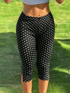 Detail of Y2K black polka dot cropped leggings with side slit design for fitness gym