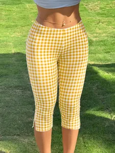 Detail of Y2K yellow gingham cropped pants featuring a stylish side slit design