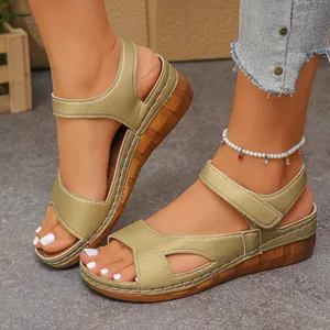 Detailed view of comfortable gold peep-toe wedge sandals with cutout design on female feet