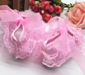Pink infant walker shoes featuring delicate lace ruffles and elegant organza ribbon bows.