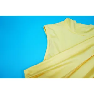 Close-up of vibrant yellow sleeveless dress featuring a high neckline and smooth texture