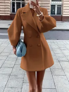Detail view of a vintage style camel wool coat with large lapels and lantern sleeves