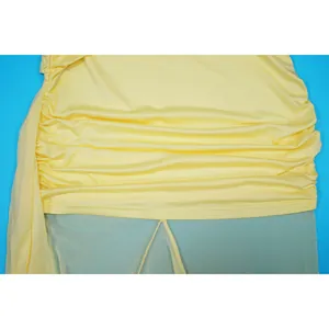 Detailed close-up showing yellow ruched fabric and sheer mesh splicing on a slim dress
