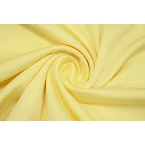 Close-up detail of soft yellow pleated polyester mesh fabric for slim fit dresses