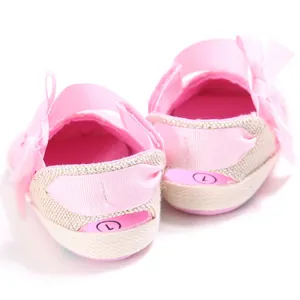 Rear view detail of soft pink baby walking shoes featuring a delicate ribbon bow