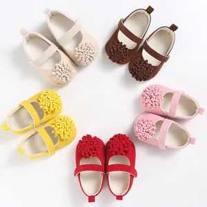 Soft-sole baby shoes featuring colorful 3D pom-pom flowers in various vibrant colors