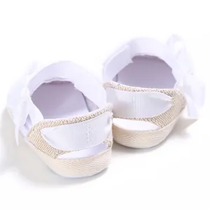 Rear view of white hollow baby walking shoes featuring elegant ribbon bows on heels