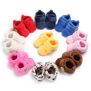 Variety of colorful plush baby booties with soft soles and velcro straps.