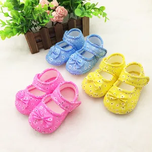 Detail view of soft-soled baby shoes with floral patterns and cute bow accents in 3 colors.