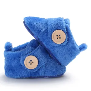 Soft blue plush infant walker shoes with decorative wooden button and velcro strap