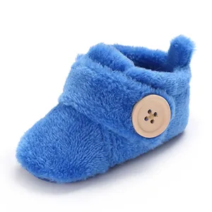 Detailed view of soft blue plush baby walker shoe with a decorative wooden button