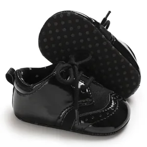 Detailed view of black patent leather baby brogue walking shoes with anti-slip soles