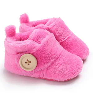 Close-up detail view of soft pink fuzzy plush baby pre-walker booties with button