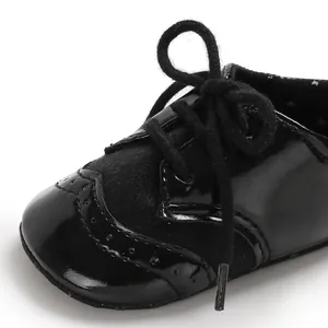 Detailed macro view of black baby toddler leather shoe with elegant brogue wingtip