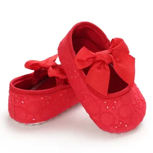 Vue détaillée des chaussures souples pour bébé rouges avec broderie et nœud