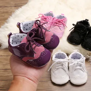 Close-up of baby brogue shoes in various colors with soft soles and star lining