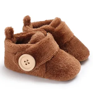 Detailed view of soft brown plush winter baby walking shoes with wooden button