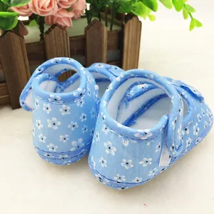Close-up of blue floral baby walker shoes with soft non-slip sole and hook-loop strap.