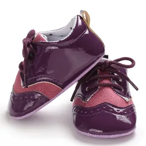 Close-up detail of purple baby brogue shoes featuring glossy finish and lace-up style