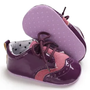 Detailed view of purple and pink lace-up baby pre-walker shoes with non-slip soles