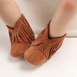Close-up of brown suede baby boots with stylish tassel detailing and zipper closure.