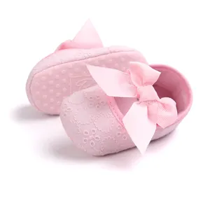 Detailed view of pink embroidered baby princess shoes with a decorative soft sole and bow