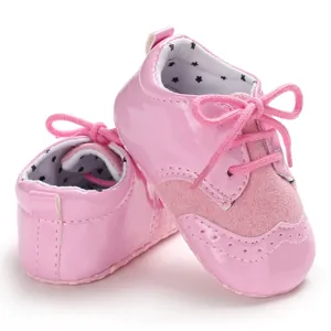 Detail view of pink patent leather baby walking shoes with star-patterned lining.
