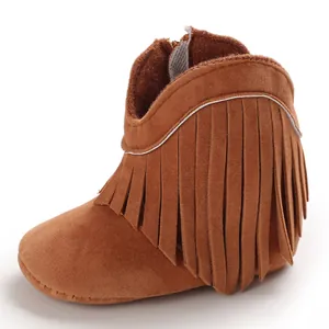 High-quality close-up of brown suede infant boots with stylish fringe decoration