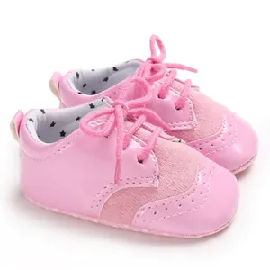 Close-up detail of soft pink patent leather baby shoes with star patterned lining