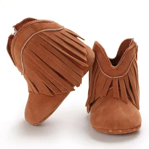 Close-up of brown suede baby boots with fringe details and anti-slip soft soles