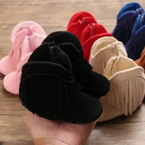 Close-up view of colorful baby fringe boots with soft tassel decorative details